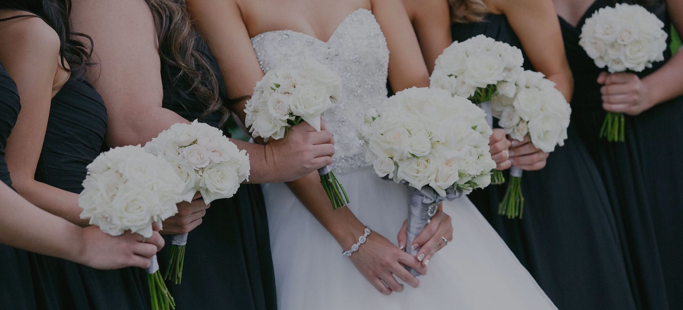 image of bride & bridesmaids holding their bouquets.